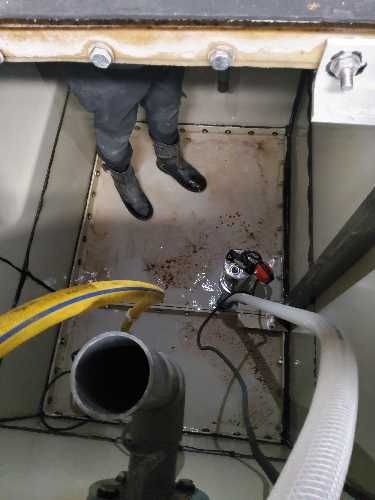 Cold water storage tank cleaning in progress at occupied student accommodation