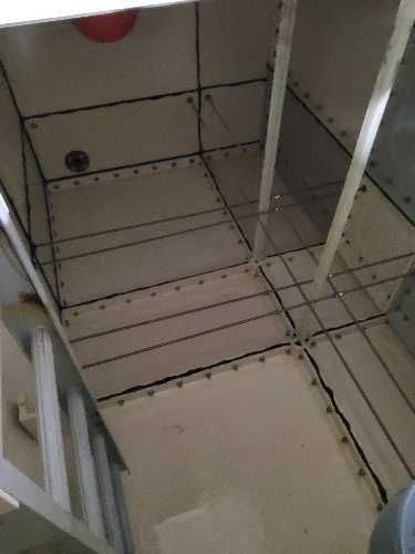 Sediment build-up inside cold water storage tank at residential apartment block